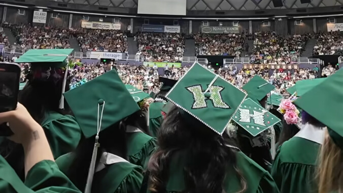 U H Manoa grads graduation caps in the Stan Sheriff Center
