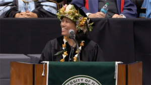 Chillingworth in cap and gown at the podium