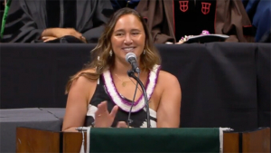 Moore smiling at the podium