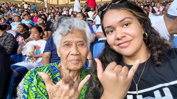 2 woman waving Shaka