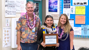 3 people, 1 person holding a framed certificate