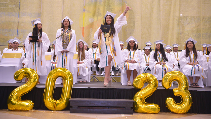 student getting diploma on stage