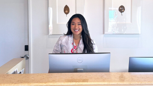 woman standing behind a computer