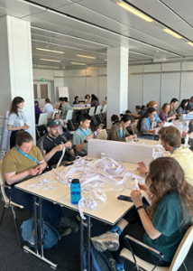 people in a room working with hands on materials