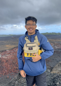 person headshot in front of a volcano