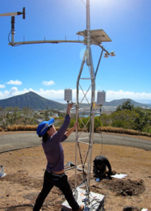 person installing a large weather station