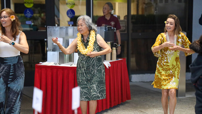 Three women dancing hula