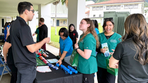 people talking to someone next to information table