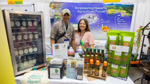 Two people smiling at a table showcasing products