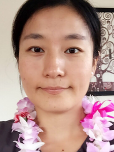 Photo of student Wenyi Ling with lei on