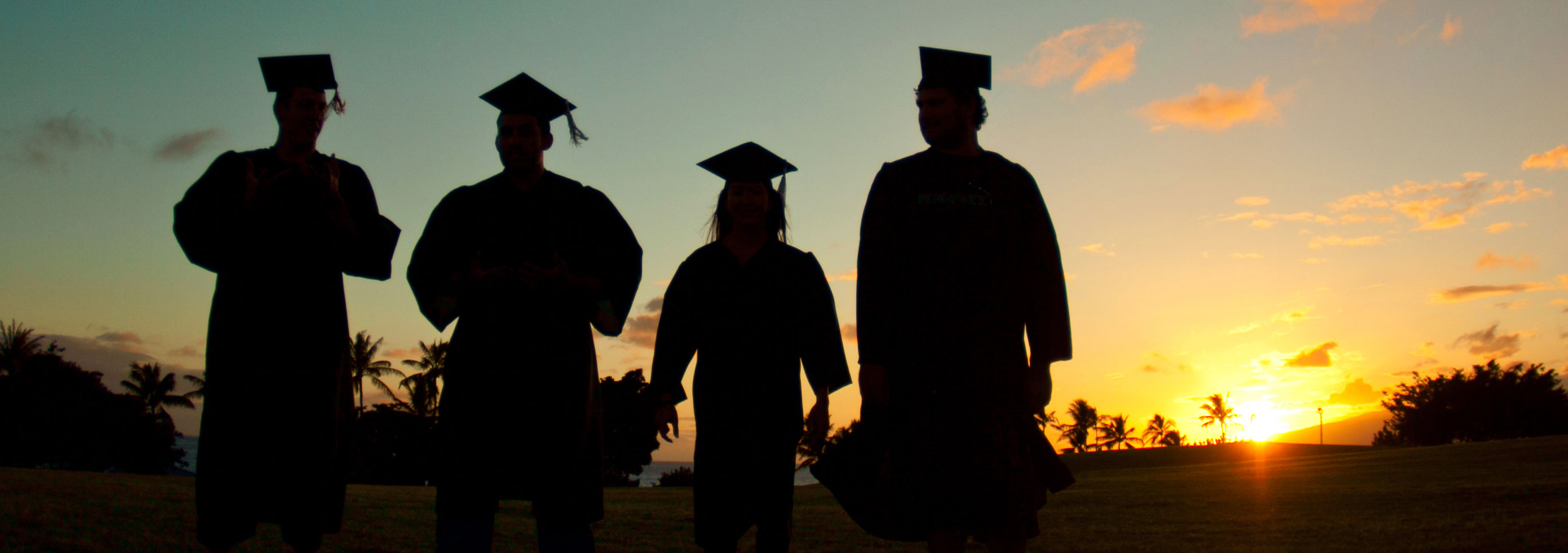 graduates at sunset